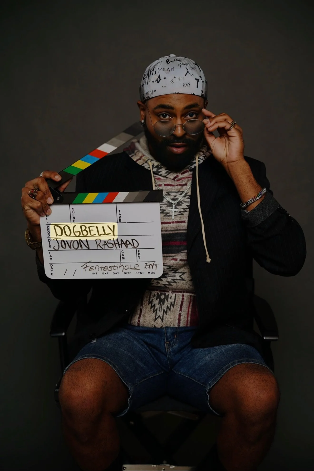 Jovon Dizard seated with a DogBelly clapperboard